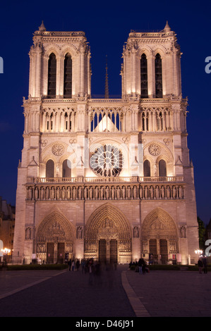 Iconic French architecture. The famous West Front of Notre Dame Cathedral, floodlit by night. A great Gothic masterpiece in the centre of Paris. France. Stock Photo