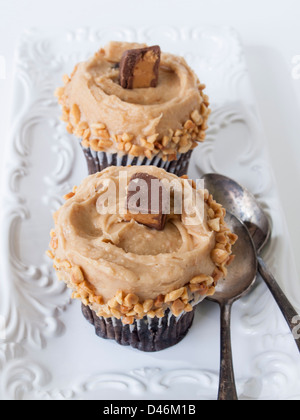 Gourmet Reese's peanut butter cups cupcake on white backround. Stock Photo