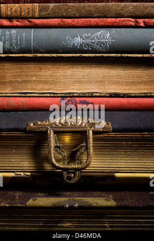 A stack of antique books and photo albums sit on a shelf. Stock Photo
