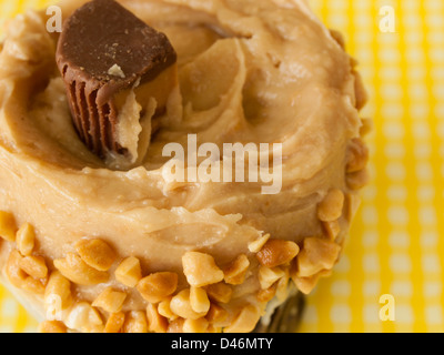 Gourmet Reese's peanut butter cups cupcake on yellow backround. Stock Photo