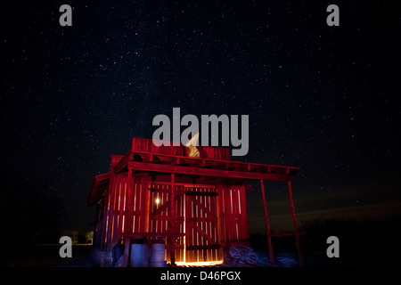 Old western blacksmith shop in west Texas under a night time sky painted with light Stock Photo