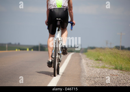 Cyclist riding on a deserted highway