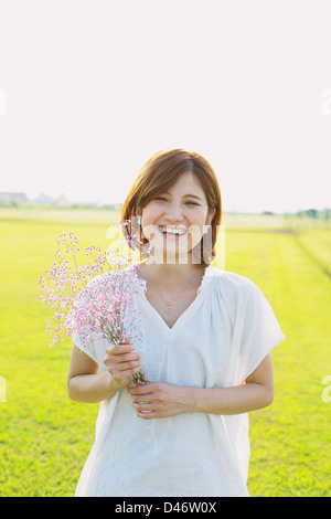 Woman Smiling With a Bouquet Of Flowers Stock Photo