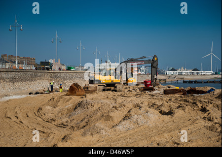 Repair work being carried out on the seawall at Lowestoft's south beach. Gulliver shown in the background. Stock Photo