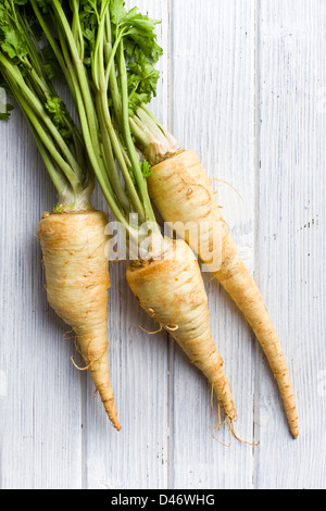fresh parsnip on wooden table Stock Photo