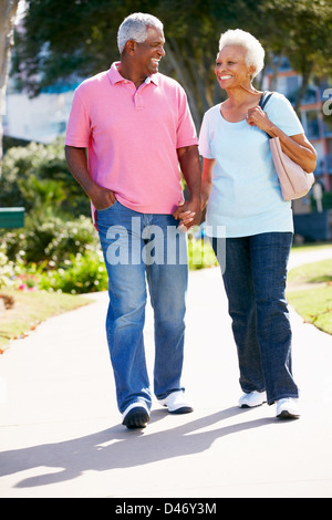 Senior Couple Walking In Park Together Stock Photo