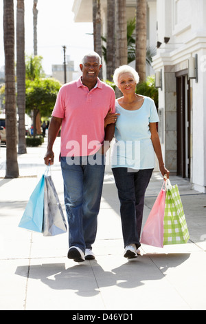 Senior Couple Carrying Shopping Bags Stock Photo