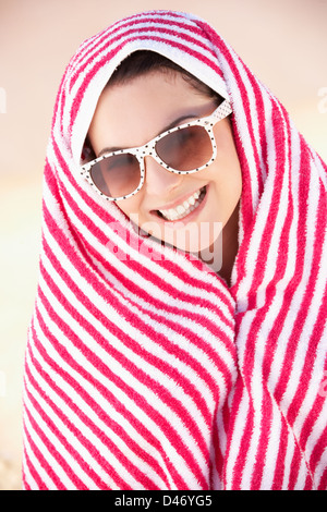 Woman Sheltering From Sun On Beach Holiday Stock Photo