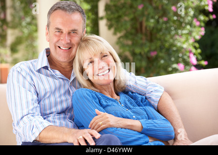 Senior Couple Relaxing On Sofa At Home Stock Photo