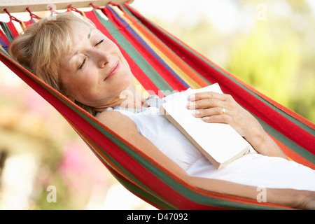 Senior Woman Relaxing In Hammock Stock Photo