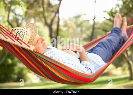 Senior Man Relaxing In Hammock Stock Photo