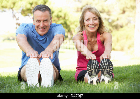 Senior Couple Exercising In Park Stock Photo