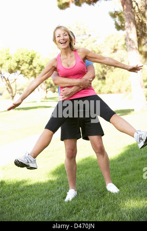 Senior Man Lifting Woman During excercise,fitness, In Park Stock Photo