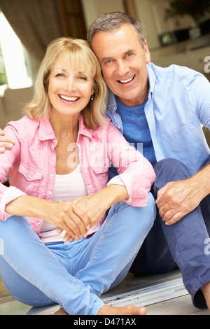 Senior Couple Sitting Outside House Stock Photo