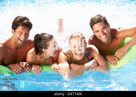 Group Of Friends Having Fun In Swimming Pool Stock Photo