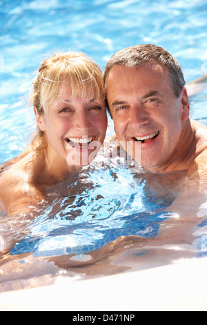 Senior Couple Having Fun In Swimming Pool Stock Photo