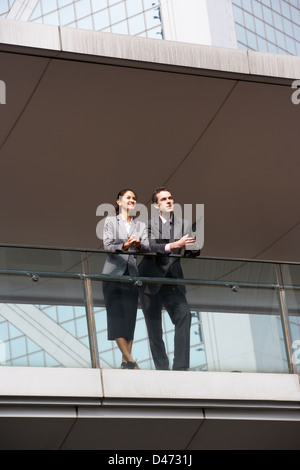Two Business Colleagues Having Discussion Outside Office Building Stock Photo