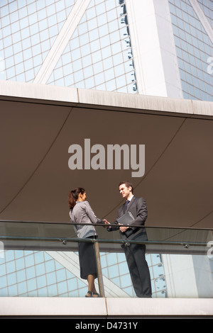 Two Business Colleagues Shaking Hands Outside Office Building Stock Photo