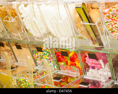 Frozen yogurt toppings bar. Yogurt toppings ranging from fresh fruits, nuts, fresh-cut candies, syrups and sprinkles. Stock Photo