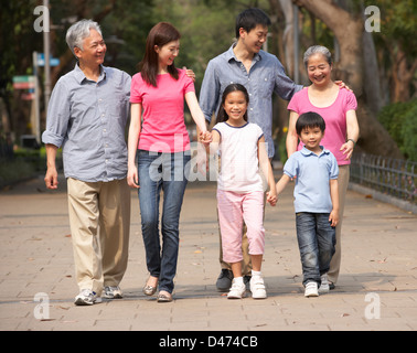 Portrait Of Multi-Generation Chinese Family Walking In Park Together