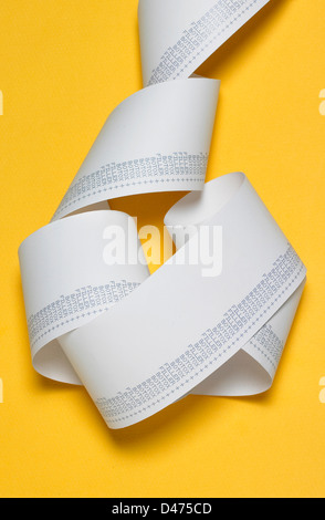 Strip of receipt cut out yellow background Stock Photo