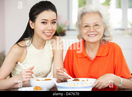 Chinese Mother And Adult Daughter Eating Meal Together Stock Photo