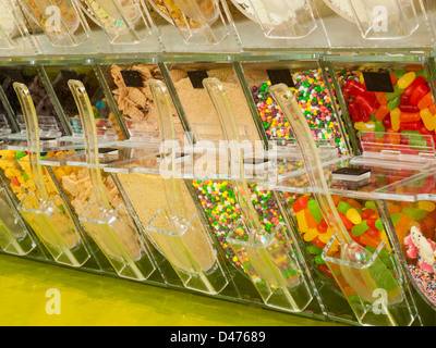 Frozen yogurt toppings bar. Yogurt toppings ranging from fresh fruits, nuts, fresh-cut candies, syrups and sprinkles. Stock Photo