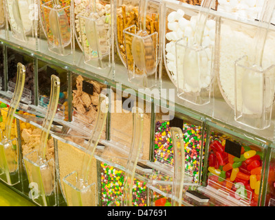 Frozen yogurt toppings bar. Yogurt toppings ranging from fresh fruits, nuts, fresh-cut candies, syrups and sprinkles. Stock Photo