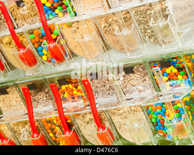 Frozen yogurt toppings bar. Yogurt toppings ranging from fresh fruits, nuts, fresh-cut candies, syrups and sprinkles. Stock Photo