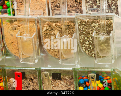 Frozen yogurt toppings bar. Yogurt toppings ranging from fresh fruits, nuts, fresh-cut candies, syrups and sprinkles. Stock Photo