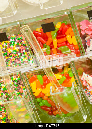 Frozen yogurt toppings bar. Yogurt toppings ranging from fresh fruits, nuts, fresh-cut candies, syrups and sprinkles. Stock Photo