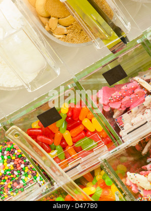 Frozen yogurt toppings bar. Yogurt toppings ranging from fresh fruits, nuts, fresh-cut candies, syrups and sprinkles. Stock Photo