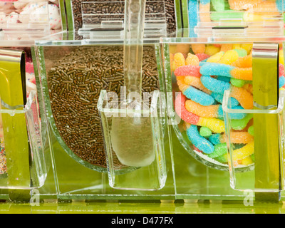 Frozen yogurt toppings bar. Yogurt toppings ranging from fresh fruits, nuts, fresh-cut candies, syrups and sprinkles. Stock Photo