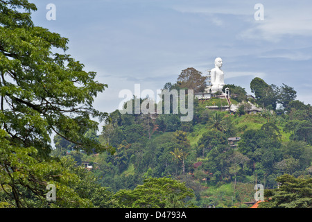 MASSIVE WHITE  BUDDHA  FIGURE ON A HILL TOP OVERLOOKING KANDY IN SRI LANKA Stock Photo