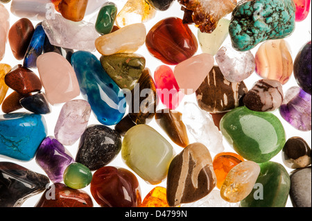 Assortment of polished semi-precious gem stones shot in the studio against white background.