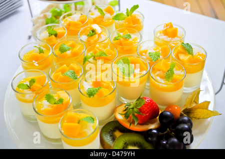 Thai traditional dessert, Mango with sticky rice and coconut milk serve in small glass. Stock Photo