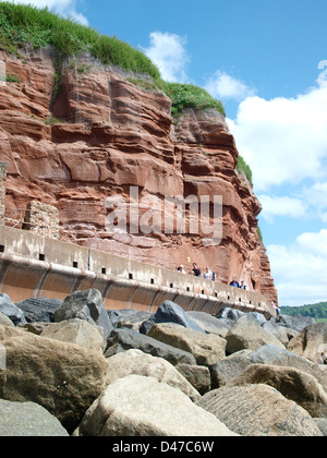Underneath Red Rocks Red sandstone rock at Sidmouth with walkway underneath Stock Photo - Alamy