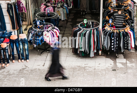 a woman walks next to a shop in istanbul street Stock Photo