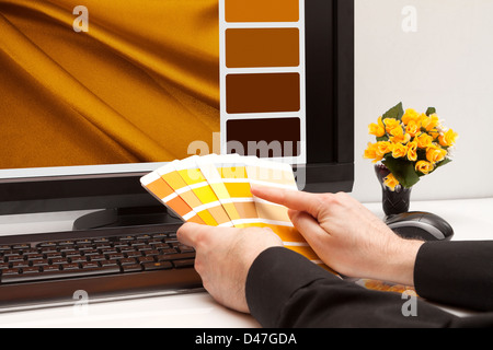 Graphic designer at work. Color samples. Brown, yellow images Stock Photo