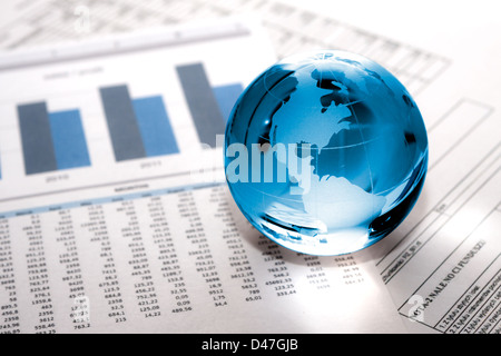 Globe showing North America and resting on financial papers Stock Photo