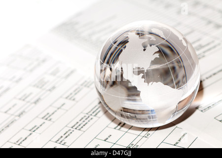 Globe showing North America and resting on financial papers Stock Photo