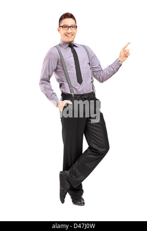 Full length portrait of a stylish smiling male pointing isolated against white background Stock Photo
