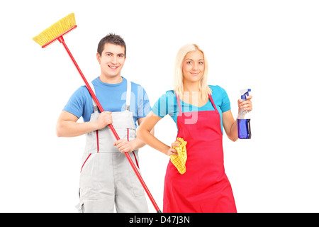 Male and female cleaners with cleaning supplies posing isolated on white background Stock Photo