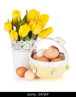 Fresh yellow tulips and eggs in bowl. Isolated on white background Stock Photo