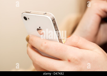 Girl holding iPhone 4s Stock Photo