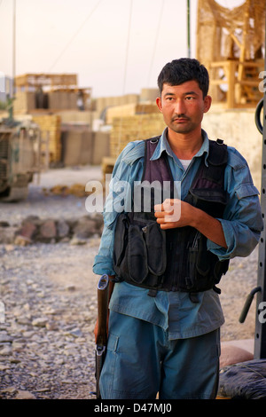 Kandahar, Afghanistan - September 24, 2010:  An Afghan National Policeman waits outside as his commander to meets with US Forces