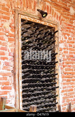 old wine bottles left in a niche on the wall Stock Photo