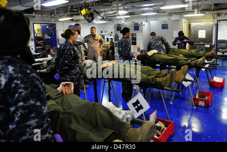 Hospital corpsmen monitor patients in medical triage during a mass casualty drill. Stock Photo