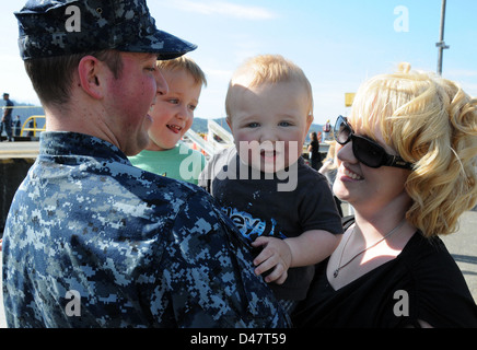 A Sailor greets his family during the ship's return to its homeport of Naval Base Kitsap-Bangor. Stock Photo