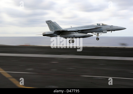 A U.S. Navy jet launches from the deck of USS Dwight D. Eisenhower (CVN 69) during flight operations, showcasing the ship’s capability for airborne missions in support of naval operations. Stock Photo